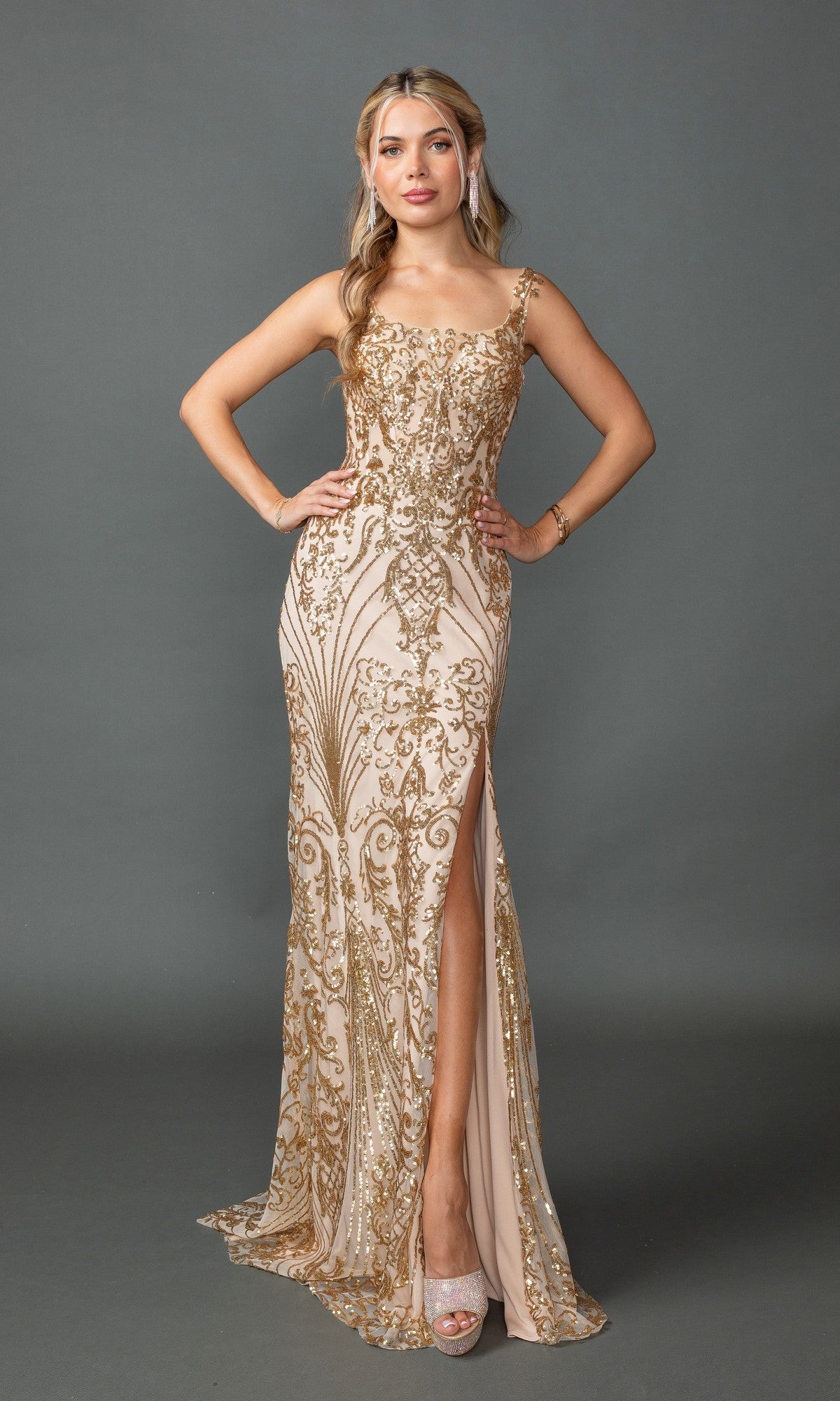 A woman stands confidently in the Champagne Long Sequin-Print Prom Dress (Dancing Queen 4461), featuring a sleeveless, floor-length silhouette with gold embroidery, thigh-high slit, and strappy back, against a plain gray background.